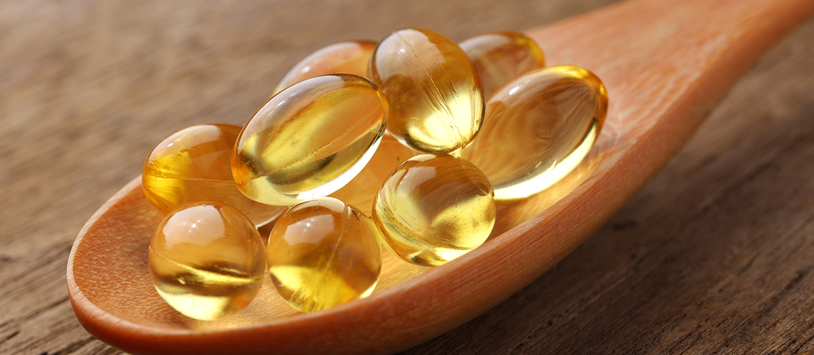 Fish oil capsules in a spoon