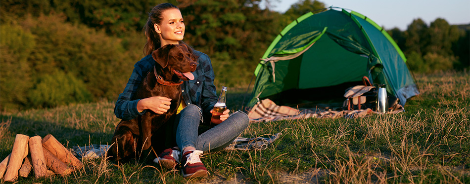 Woman camping with dog