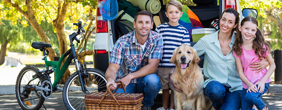 Happy family getting ready for road trip on a sunny day